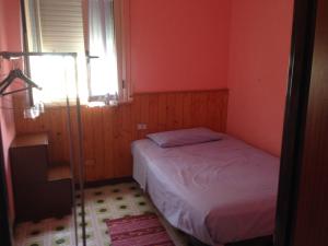 a small bedroom with a bed and a window at natura e relax sul mare in Gela