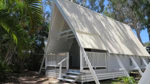a small white house with a gambrel roof at Picnic Bay Chalet Unit 2 in Picnic Bay