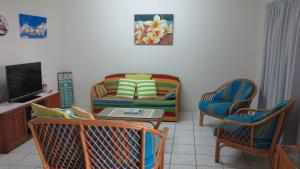 a living room with a couch and a table and chairs at Magnetic Shores Unit 3 in Arcadia