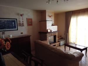 a living room with a couch and a fireplace at Porta del Colle in Roccavivara