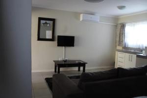 a living room with a couch and a table at Maruleng Guest House in Hoedspruit