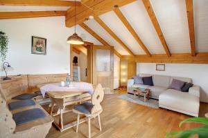 a living room with a couch and a table at Josys Ferienwohnung in Gstadt am Chiemsee