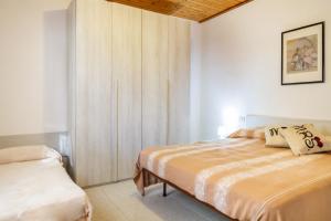 a bedroom with two beds and a cabinet at Perla marina in Grosseto