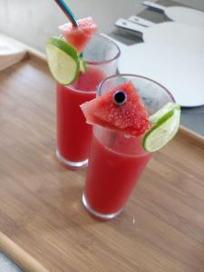 two glasses of watermelon margaritas on a cutting board at Oruwa Boutique Villas in Arugam Bay
