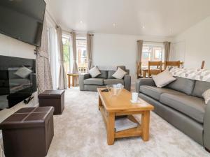 a living room with a couch and a table at Ridge's Retreat No 7 Kigbeare Lodges in Okehampton