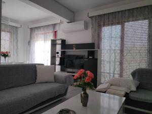 a living room with a couch and a table at Elea House in Keramoti