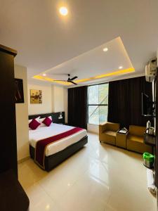 a bedroom with a large bed and a couch at The Porch Inn Hotel/Service Apartments in Bangalore