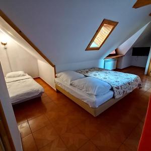 a bedroom with two beds and a skylight at Kazkowa Koliba in Zakopane