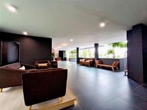 a large living room with couches and chairs at Raia Inn Penang in Bayan Lepas