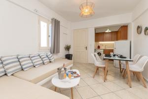 a living room with a couch and a table at GRotta Carpe Diem in Naxos Chora