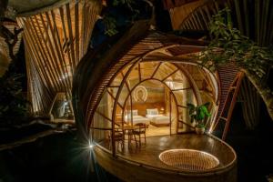 a room with a round room with a bed and a table at Ulaman Eco Luxury Resort in Tabanan