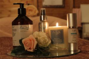 a table with two bottles and a candle and flowers at Stonehenge Inn in Durrington