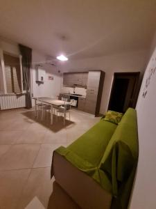 a room with a bed and a table and a kitchen at Villa Luja in Arielli +10 photos