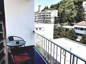 a balcony with a table and chairs on a building at Apartman_trile in Ulcinj