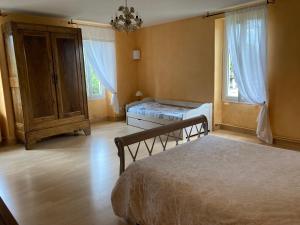 Cama ou camas em um quarto em La tuilerie