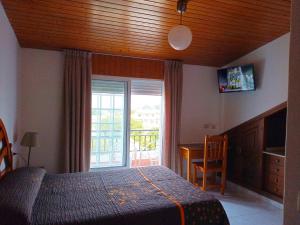 a bedroom with a bed and a sliding glass door at Casa Angelina in O Grove +96 photos