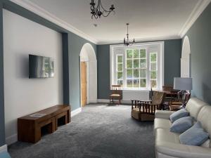 a living room with a couch and a table at Red Barns Bed & Breakfast in Redcar