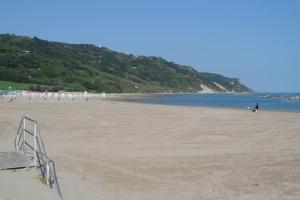 a beach with a bunch of people on it at CASA FLAMINIA in Pesaro