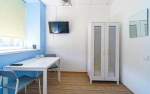 an office with a desk and chairs and a cabinet at Traveler's haven in Odesa