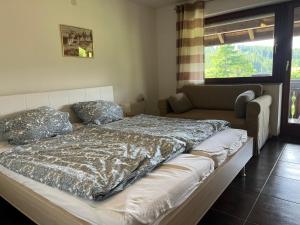 a bedroom with a bed and a couch in it at Ferienhaus Samy in Feldberg