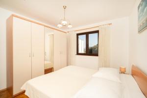 Ένα ή περισσότερα κρεβάτια σε δωμάτιο στο Apartmani Zlata