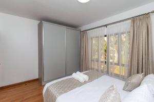 a bedroom with a bed and a large window at CySuites Apartment Hotel in Nairobi