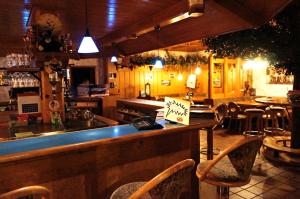 a bar with chairs and a counter in a restaurant at Alemannenhof Hotel Engel in Rickenbach