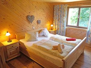 a bedroom with a bed in a wooden cabin at Apartment Helmreich-4 by Interhome in Sankt Gallenkirch +34 photos