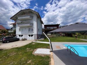 a house with a swimming pool in front of it at Apartment Frank-2 by Interhome in Feldkirchen in Kärnten