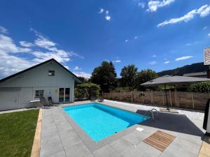 a swimming pool in the backyard of a house at Apartment Frank-1 by Interhome in Feldkirchen in Kärnten