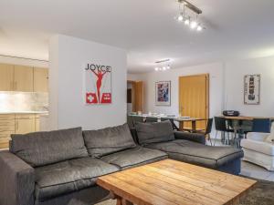 a living room with a couch and a table at Apartment Les Chouettes 22 by Interhome in Nendaz