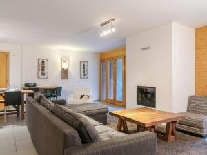 a living room with a couch and a table at Apartment Les Chouettes 22 by Interhome in Nendaz