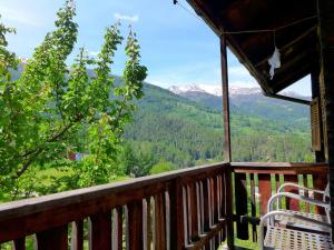 a porch with a chair and a view of mountains at Apartment Jostbiel by Interhome in Bürchen