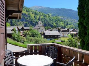 a table and chairs on a balcony with a view at Chalet Zur Säge by Interhome in Albinen