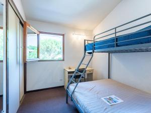 a bedroom with two bunk beds and a desk at Holiday Home Les Landaises-9 by Interhome in Lacanau-Océan