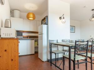 a kitchen and dining room with a table and chairs at Apartment Soleil Levant 1 et 2-2 by Interhome in Le Barcarès