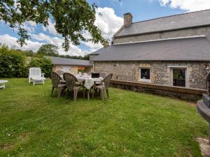 a table and chairs in the yard of a house at Holiday Home Le Repos by Interhome in Commes
