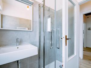 a bathroom with a sink and a shower at Holiday Home Villetta ai Pini-2 by Interhome in Calceranica al Lago