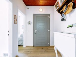 a hallway with a blue door and white walls at Holiday Home Villetta ai Pini-2 by Interhome in Calceranica al Lago