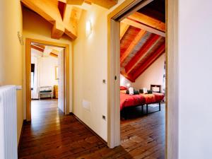 a bedroom with a red bed in a room at Apartment Deval-3 by Interhome in Calceranica al Lago