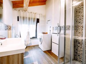 a bathroom with a sink and a refrigerator at Apartment Deval-3 by Interhome in Calceranica al Lago