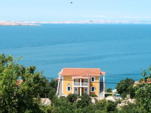 ein gelbes Haus mit dem Ozean im Hintergrund in der Unterkunft Apartment Daniel - KBG404 by Interhome in Pandžinac