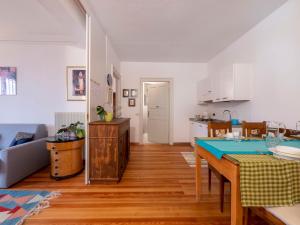 a kitchen and living room with a table and chairs at Apartment Villa Margherita-1 by Interhome in Anduins