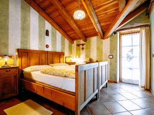 a bedroom with a bed with a wooden frame and a window at Apartment Golden by Interhome in Sanzeno