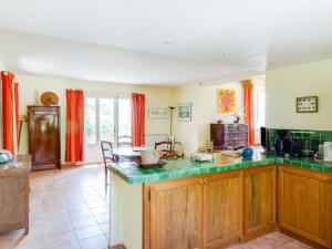 a kitchen with wooden cabinets and a green counter top at Holiday Home Les Cotes by Interhome in Saint-Martin-de-Castillon