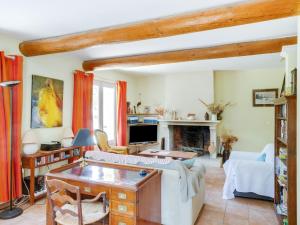 a living room with a couch and a fireplace at Holiday Home Les Cotes by Interhome in Saint-Martin-de-Castillon