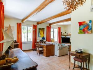 a living room with red curtains and a table at Holiday Home Les Cotes by Interhome in Saint-Martin-de-Castillon +25 photos