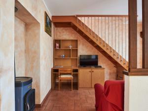 a room with a desk and a staircase at Holiday Home Leonardo by Interhome in Sorico