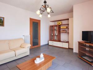 a living room with a couch and a tv at Apartment Aurora - DMA330 by Interhome in Vercana