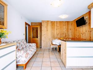 a living room with a couch and a table at Apartment Cincelli - Marmolada by Interhome in Pozza di Fassa